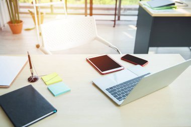 Laptop bilgisayar modeli, dijital tablet bilgisayar ve ofis masasında akıllı telefon olan modern ofis işyeri. Laptop, tablet bilgisayar, masada akıllı telefon. Tasarım sunumu veya portföy için.