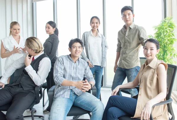 Group of initiative multi-ethnic group young business people sitting in creative modern office, business and financial concept.