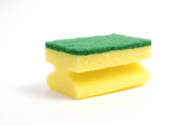 Photo of a dish sponge that consists of yellow foam and green abrasive on a white background clipart