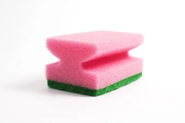 Pembe köpük ve yeşil beyaz bir arka plan üzerinde aşındırıcı oluşan bir tabak sünger fotoğrafı
