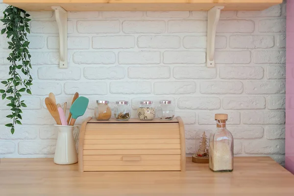 Dapur modern dengan dinding putih, meja kayu, keranjang roti, rak dan kulkas merah muda. Dekorasi dapur gaya hidup — Stok Foto