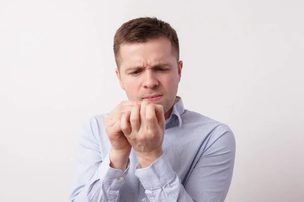 Young man looking at his fingers — Stock Photo, Image