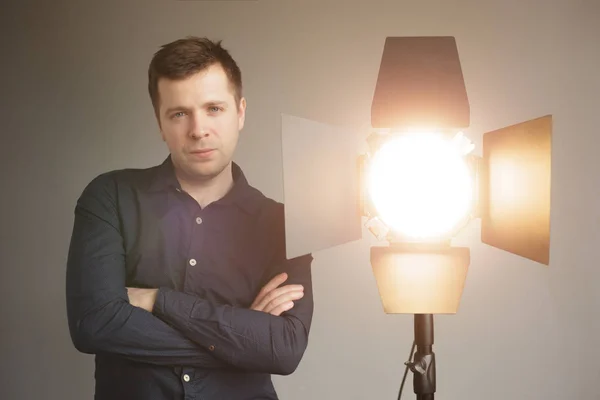 Caucasian man works with studio equipment — Stock Photo, Image