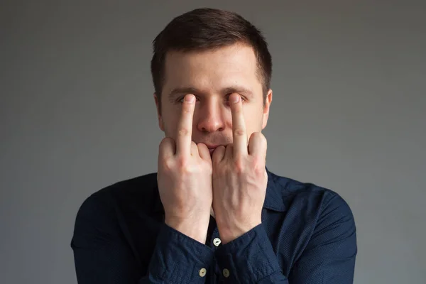 Caucasian man shows bad sign with fingers — Stock Photo, Image