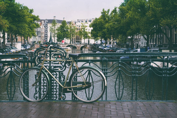 Bike on the bridge in Amsterdam Netherlands in summer. Vintage light