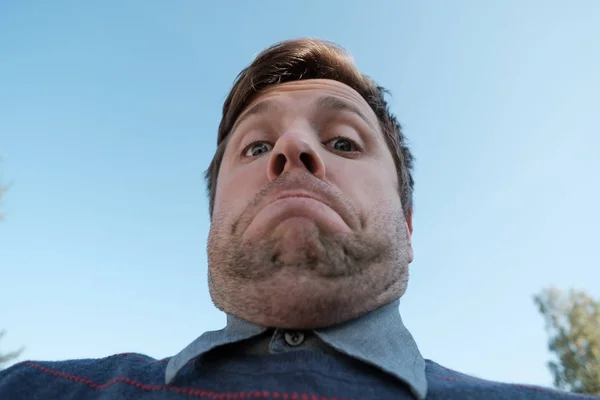 young man with a double chin - the result of poor lifestyle
