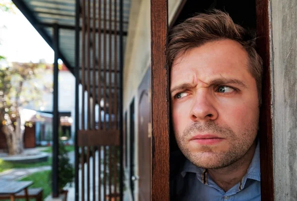 Cropped shot of senior man spying and entering through the door as concept of nosy man — Stock Photo, Image