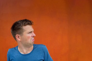 Çekici düşünceli genç adam şaşkın ve kuşku dolu.