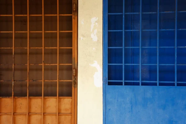 Parrilla de puerta azul y naranja en la calle . — Foto de Stock