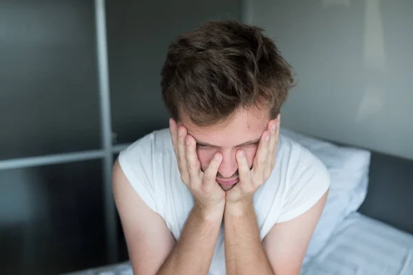 Yatakta oturmuş ve kötü duygu depresif adam — Stok fotoğraf
