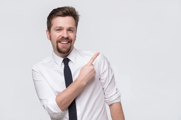 Elegante guapo joven caucásico hombre señalando a un lado . —  Fotos de Stock