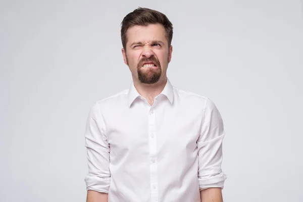 Scared young caucasian man biting lips, feeling nervous and impatient. — Stock Photo, Image
