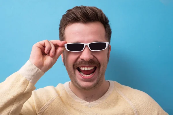 geek retro caucasian man with funny mustache sunglasses with serious emotion on face