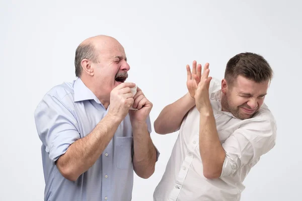 Sick bald caucasian man holding napkin or tissue, trying to cover mouth while sneezing — 스톡 사진