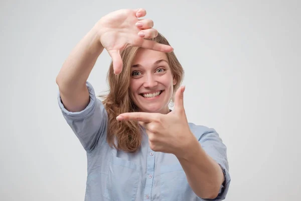 Young beautiful woman making frame with her hands smiling over white background. P — ストック写真