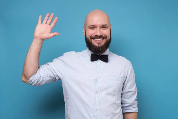 Handsome bearded man with bowtie saluting saying hello. — 스톡 사진