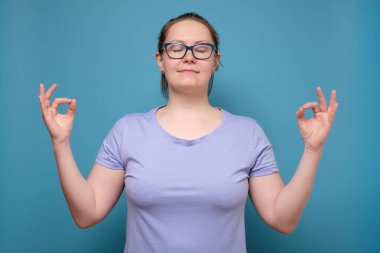 Huzurlu, huzurlu, olgun bir kadın kendini rahatlamış hisseder, konsantre olmaya çalışır, gözlerini kapatır, sessizlikten zevk alır, dengeyi bulmaya çalışır. Sakin atmosfer ve meditasyon. Paniğe kapılmayın..