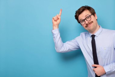 Gözlüklü memnun genç adam işaret parmağını kaldırıyor.