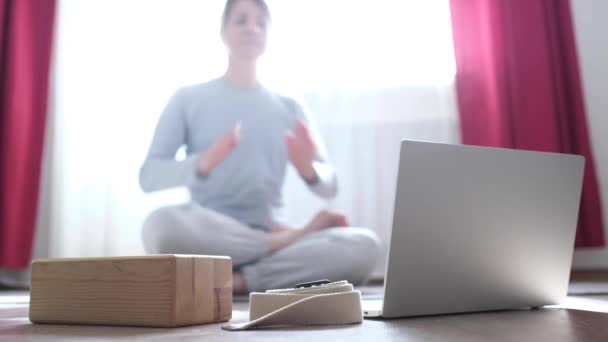 Young woman sending air kiss to her friend after online yoga training — Stock Video