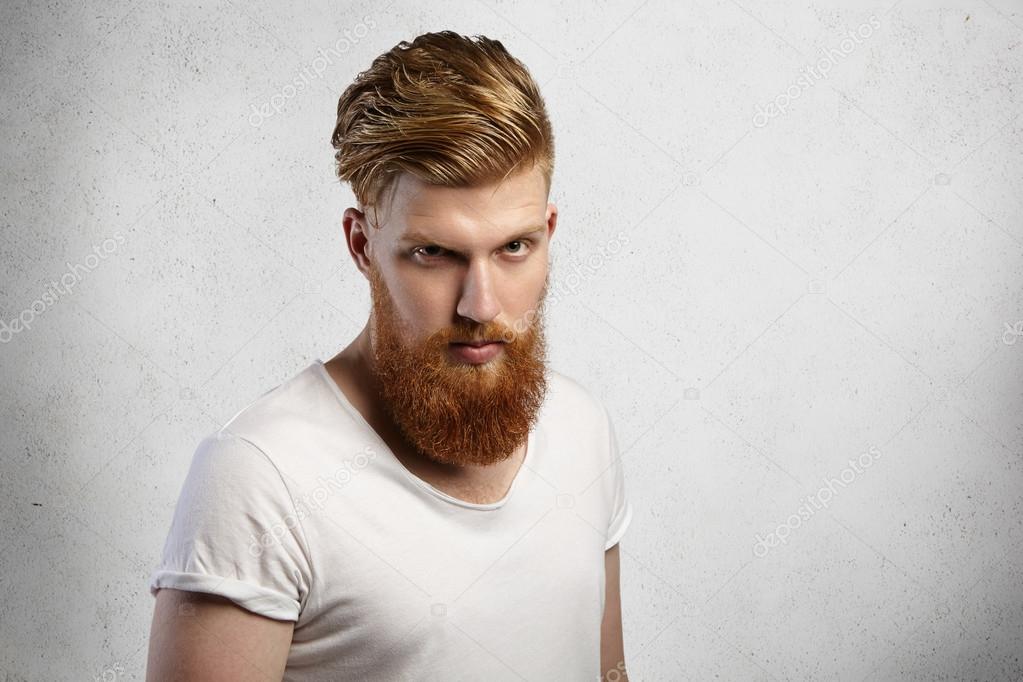 Headshot of self-assured bearded hipster with stylish haircut and ...