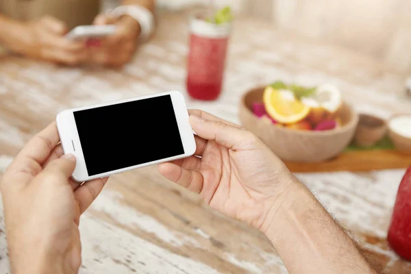 man\'s hands with generic smartphone