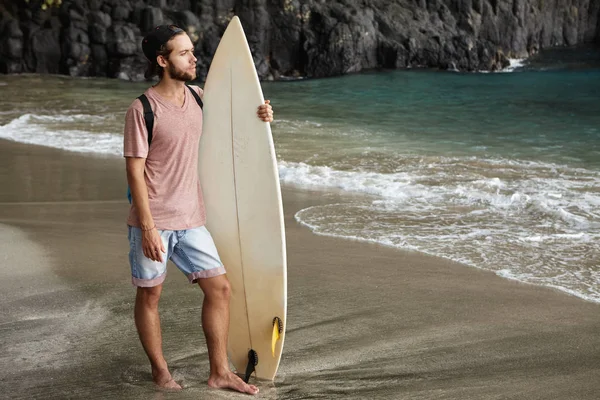 male posing with surfboard