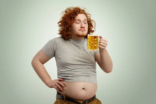 man enjoying smell of cold frothy lager