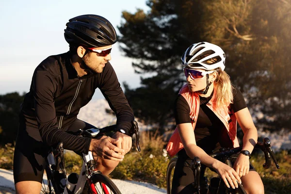 male and female cyclists having conversation