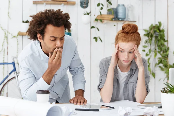 female engineer holding hands on head in despair