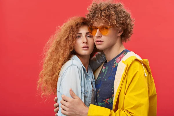 couple dressed in trendy clothes posing