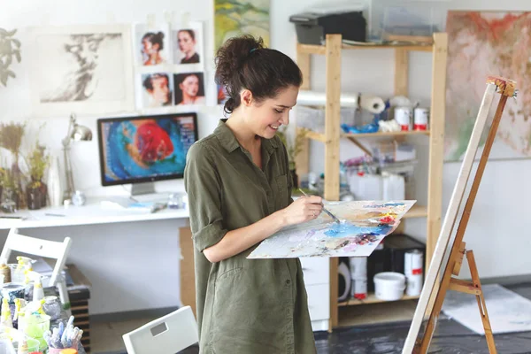 woman artist in shirt of military color