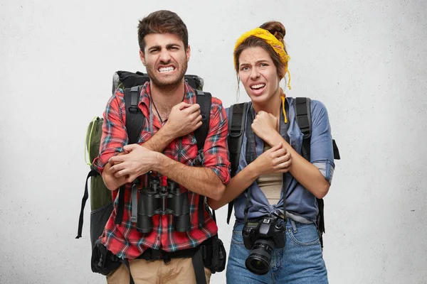 unhappy male and female tourists