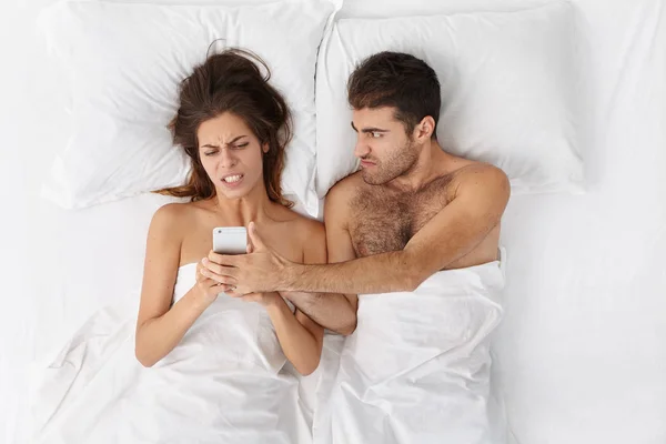 couple fighting in bed