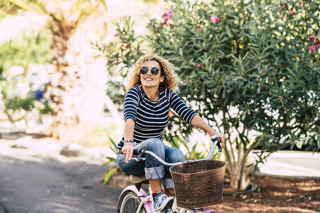 Cheerful woman riding bike and smiling for happiness