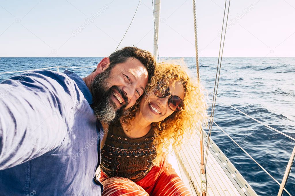 Cheerful people and happy caucasian couple enjoying the outdoor leisure activity during sea vacation 