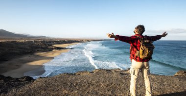 Standing man enjoying the travel and nature landscape in front of him