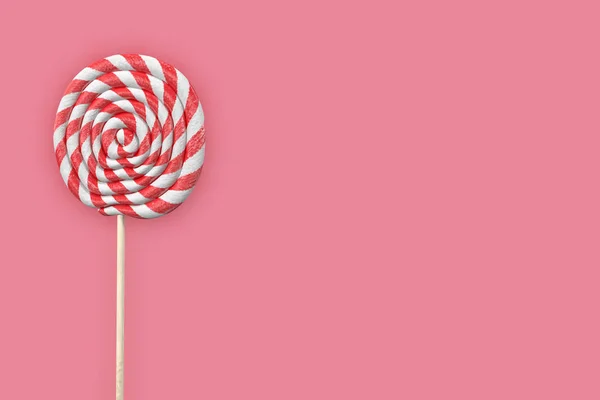 Achtergrond met een ronde gestreepte lolly op roze, 3d — Stockfoto