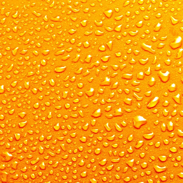 Gotas de água em fundo laranja textura colorido cachoeira squa — Fotografia de Stock