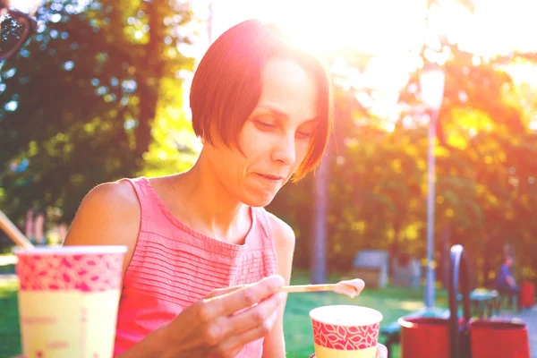 La ragazza mangia nel parco . — Foto Stock