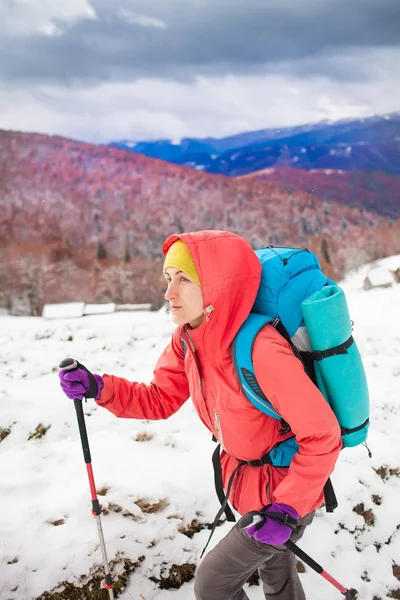 Ragazza con zaino che cammina sulla neve in montagna . — Foto Stock