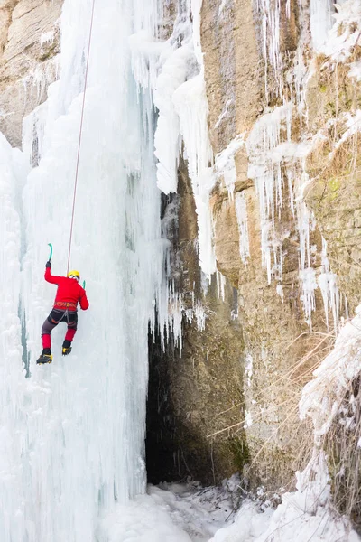 The climber climbs on ice. Stock Photo