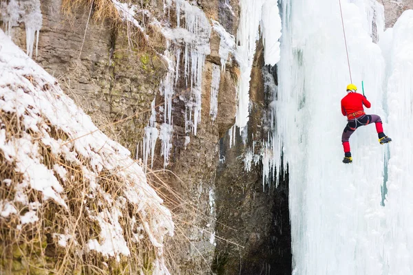 The climber climbs on ice. Royalty Free Stock Photos
