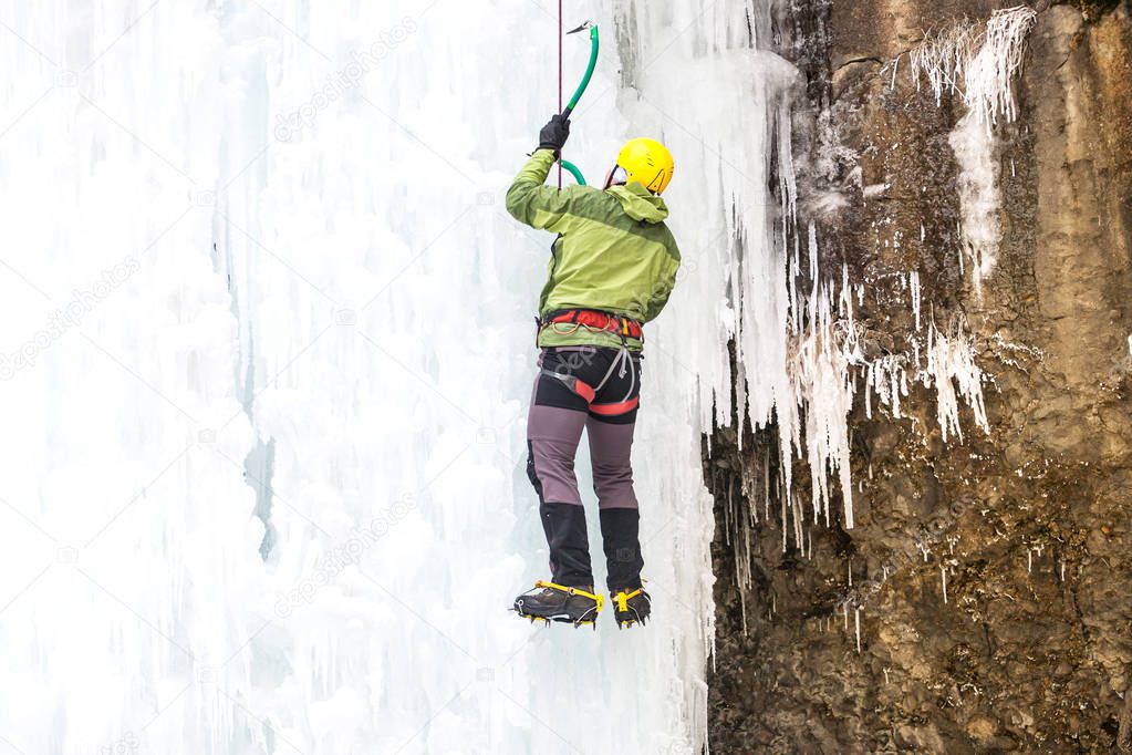 The climber climbs on ice.