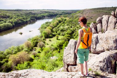 Kız bir sırt çantası ile pitoresk yerlerde yürür.