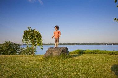 Çocuk taş üzerine tırmandı.