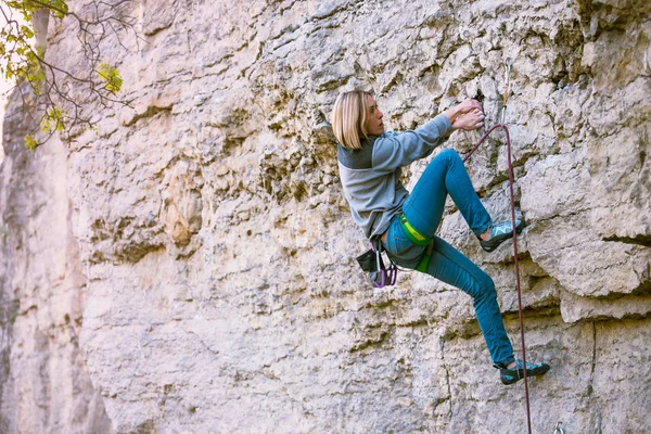 一个女人在一块岩石上登山者. — 图库照片