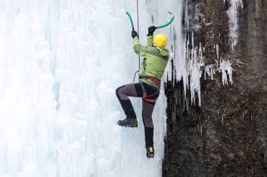 Dağcı buza tırmanıyor.