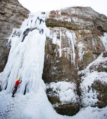 Dağcı buza tırmanıyor.