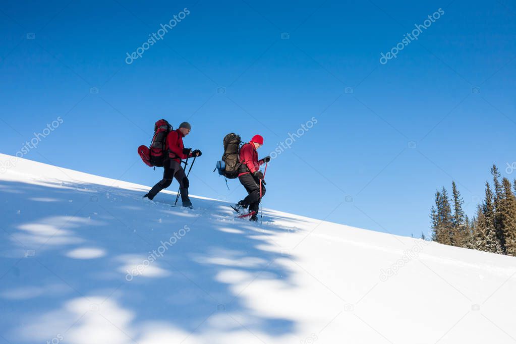 Two climbers are in the mountains.