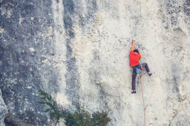 Bir adam kaya tırmanıyor.